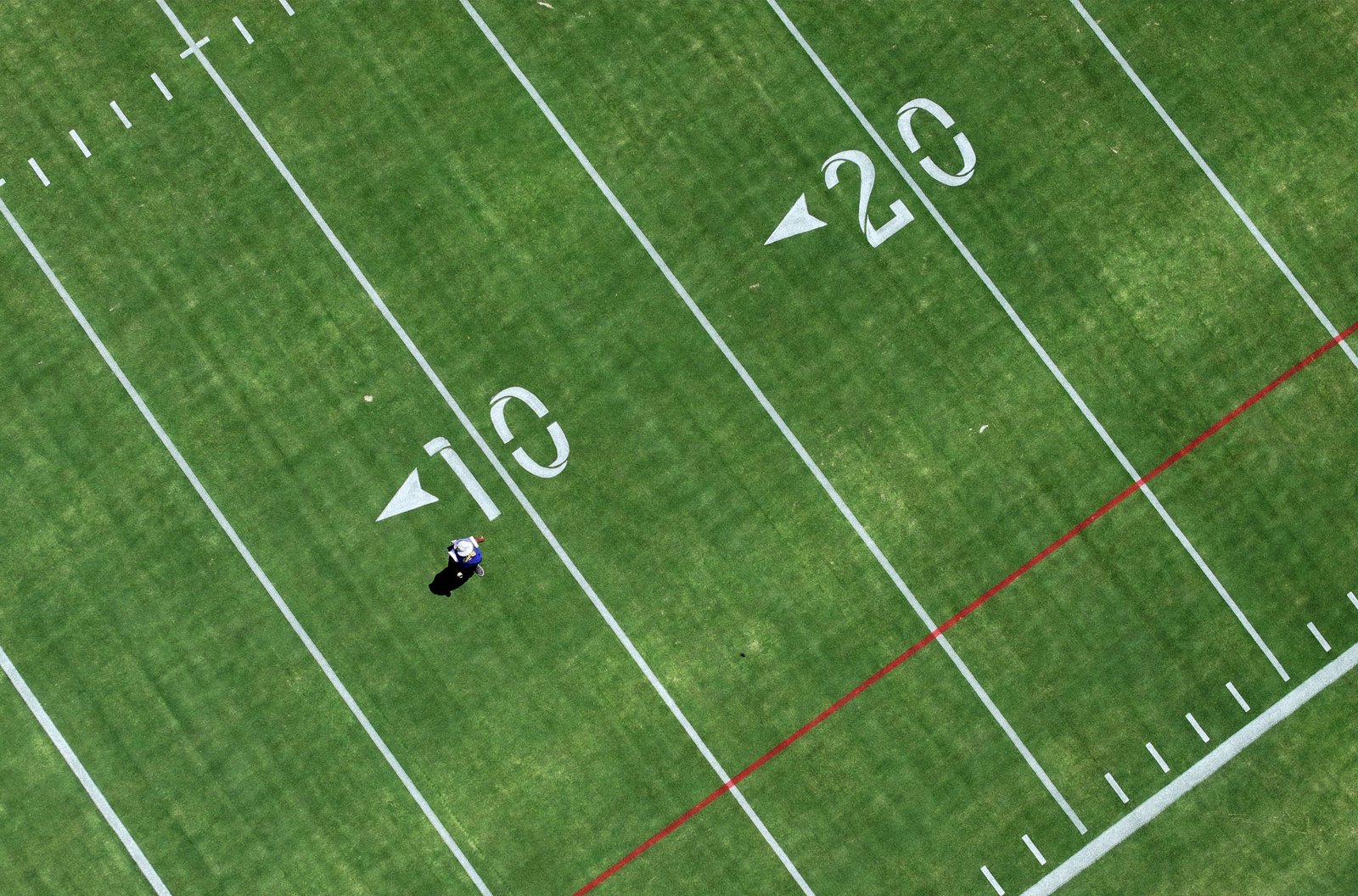 A worker crosses the field at the new Los Angeles...