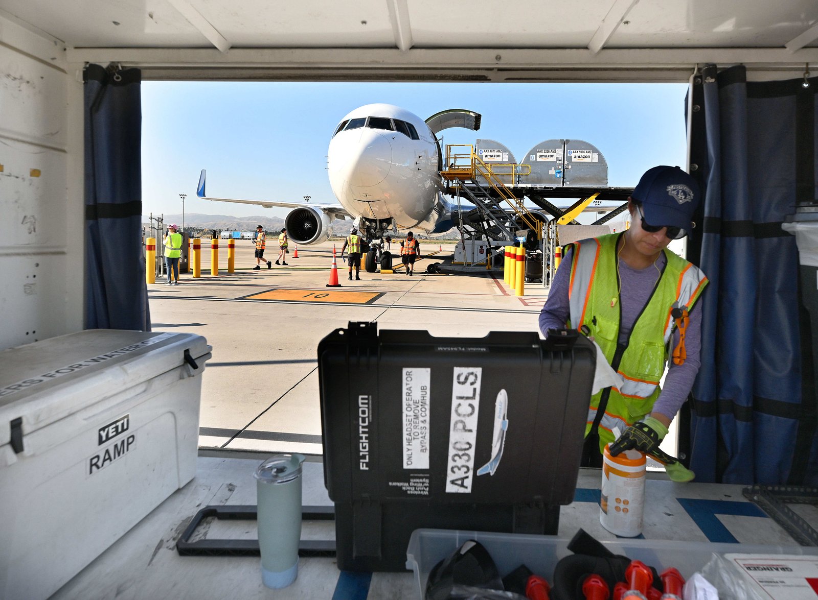 An Amazon associate prepares for a departing flight at its...