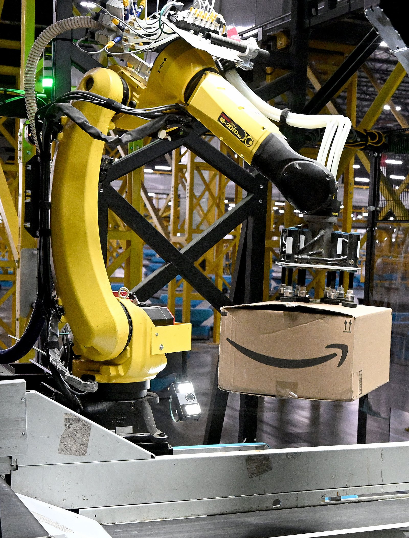 A robotic arm called a Robin picks up a package...