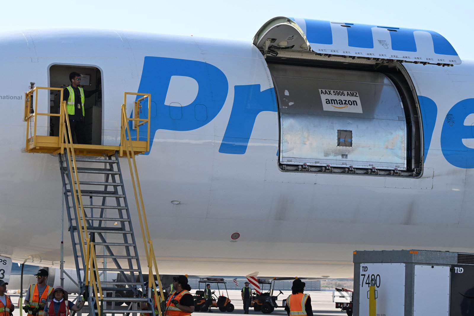 An Amazon employee closes a cargo door on a Boeing...