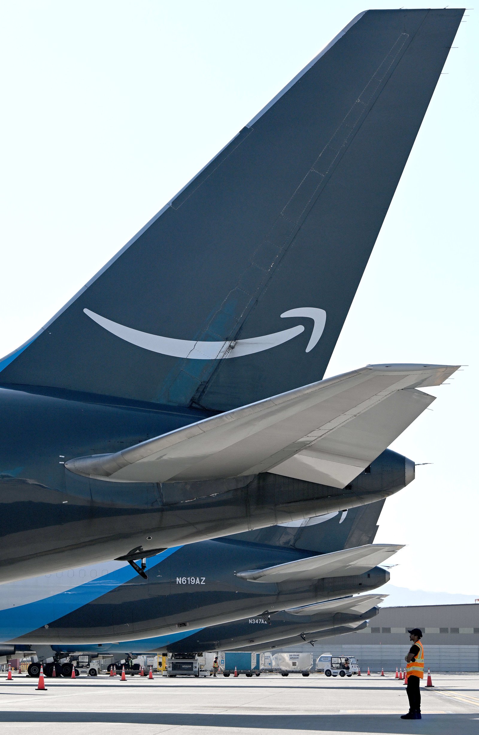 An Amazon employee waits to help guide a jet for...