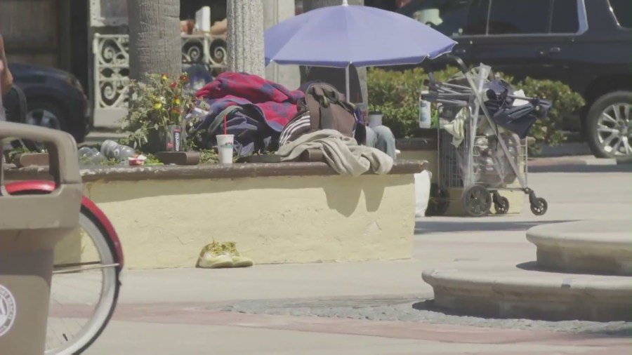 Homeless residents seen at the Newport Beach Pier area on August 29, 2024. (KTLA)