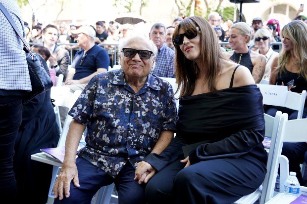 Danny DeVito, left, and Monica Bellucci arrive at a ceremony...