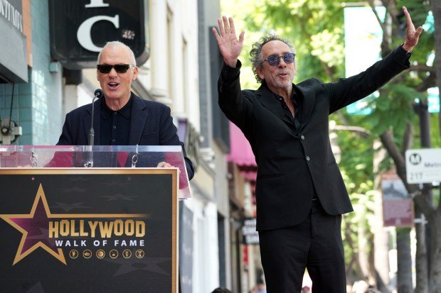 Michael Keaton, left, and Tim Burton arrive at a ceremony...