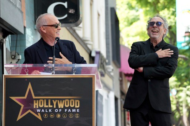 Michael Keaton, left, and Tim Burton arrive at a ceremony...