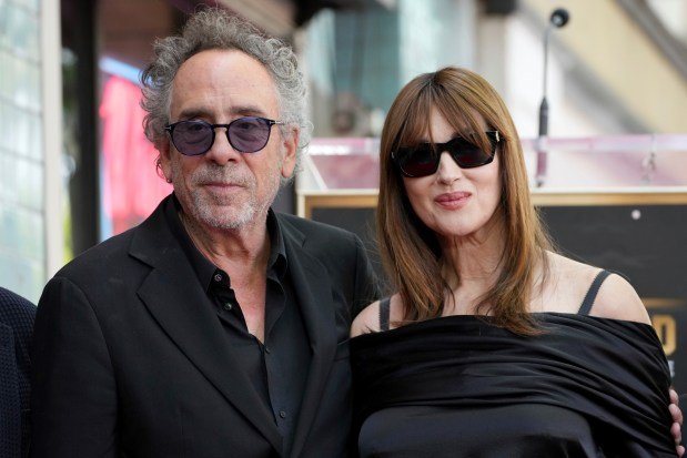 Tim Burton, left, and Monica Bellucci arrive at a ceremony...