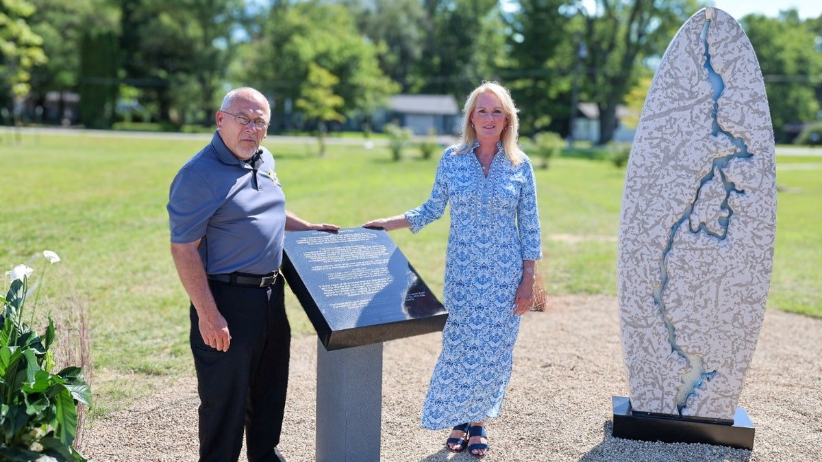 Jeff Jellison and Linda Znachko stand by the Fox Hollow Farm memorial