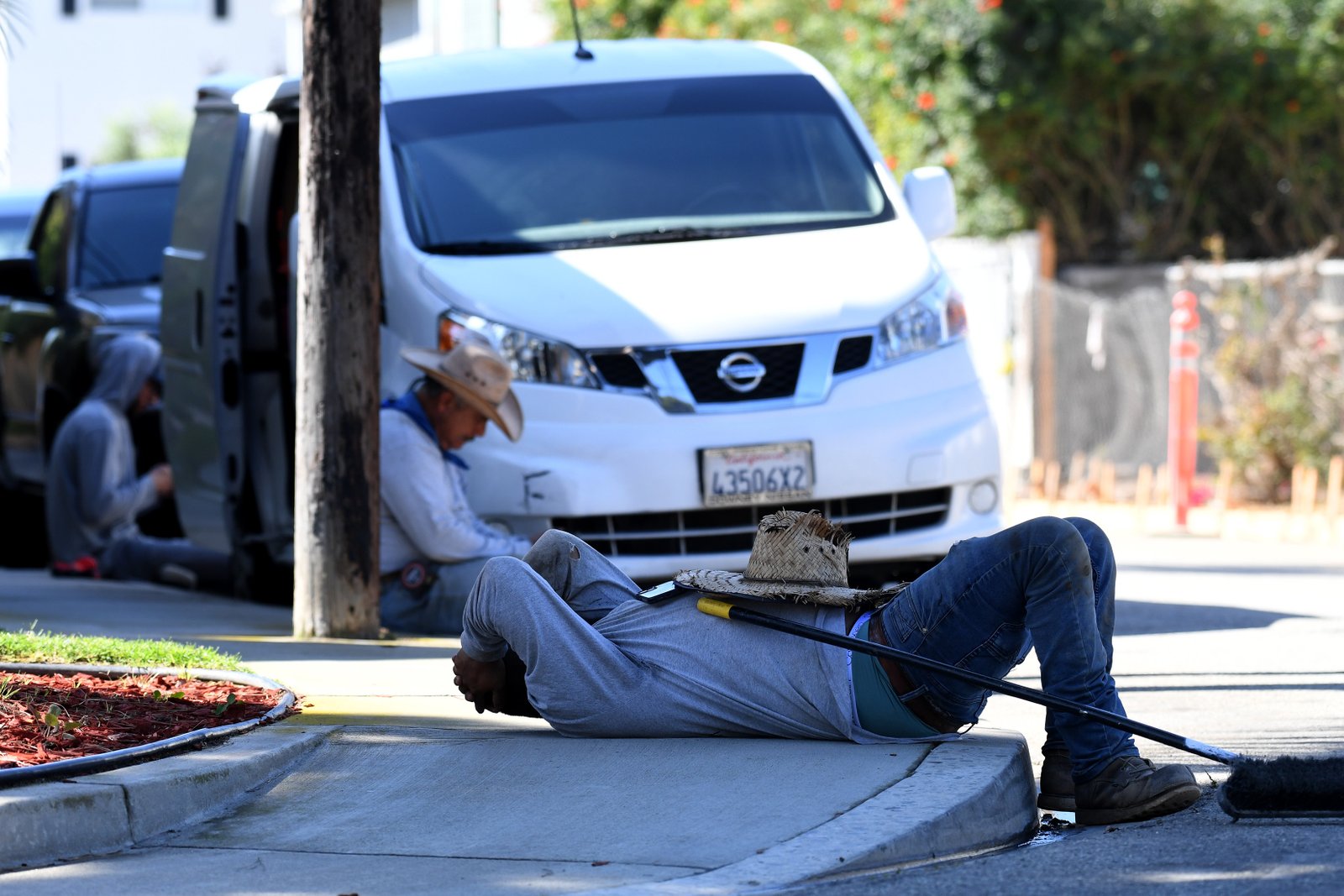 Alberto Rodriguez and fellow workers take a break from the...