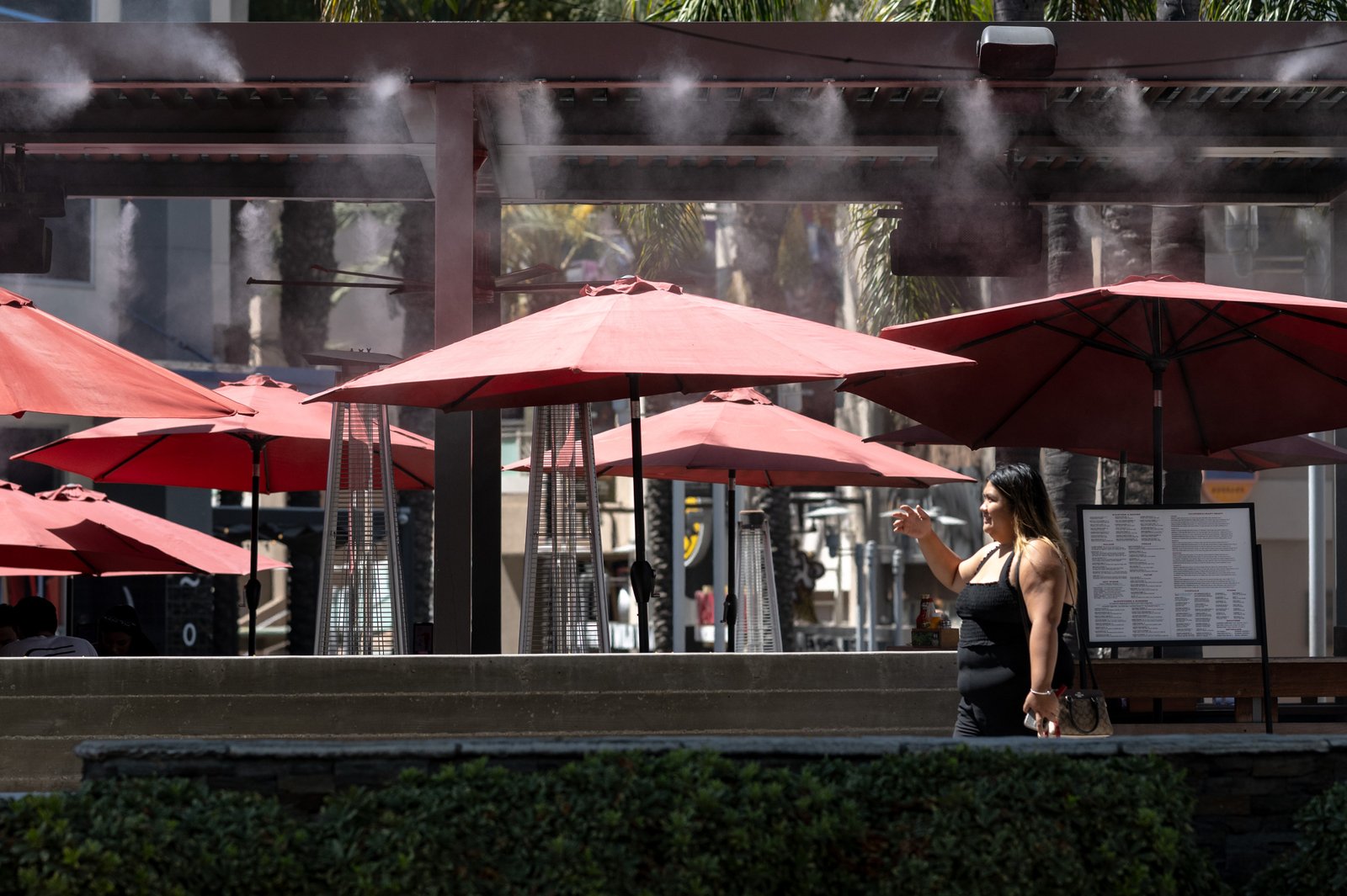 Misters and umbrellas offer a bit of relief from temperatures...