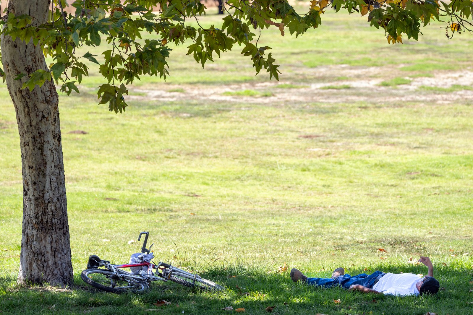 A man gets out of the heat in a shade...